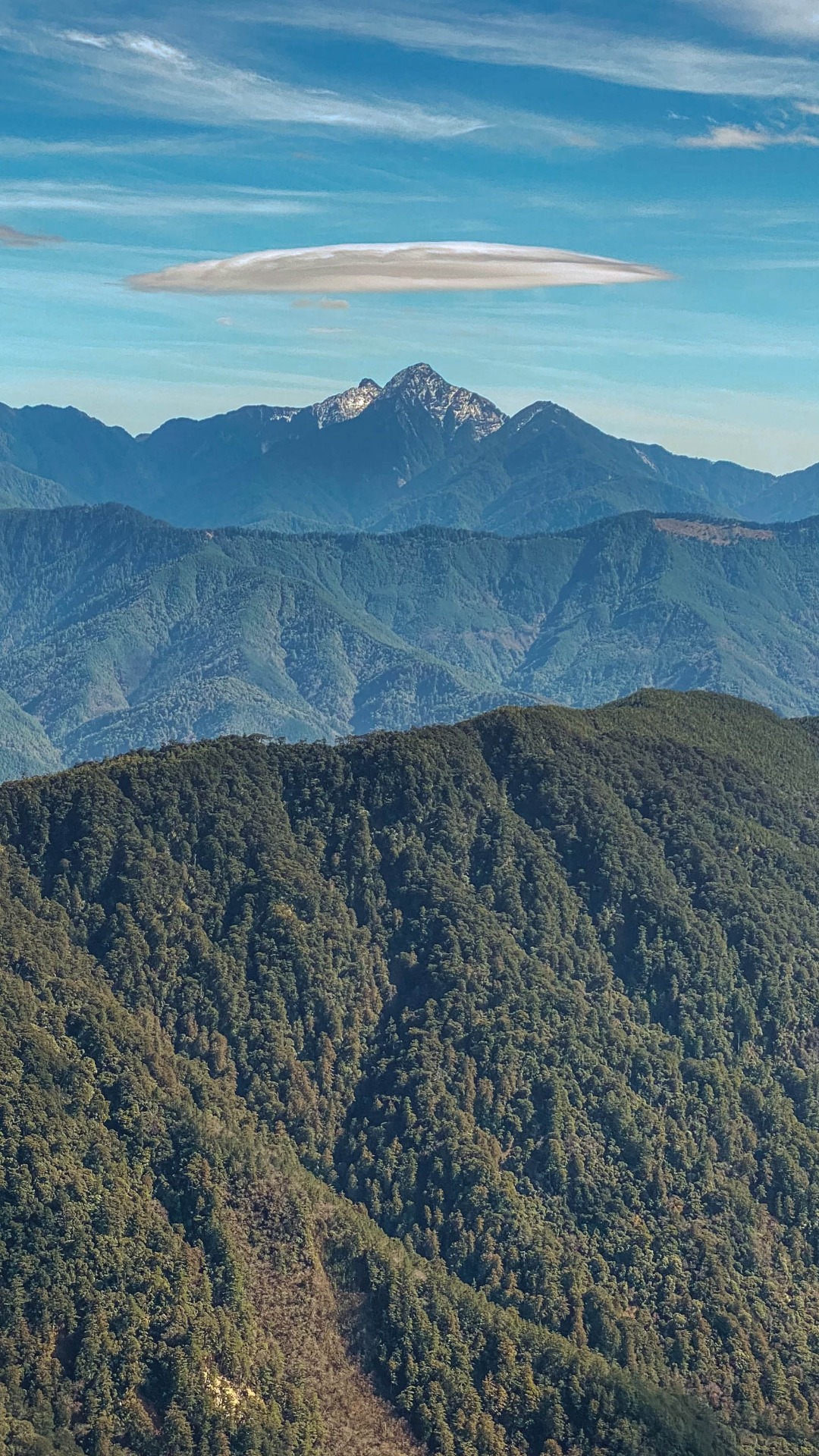戴了一圈雲帽的中央尖山,峻峭的形象多了一絲萌感。