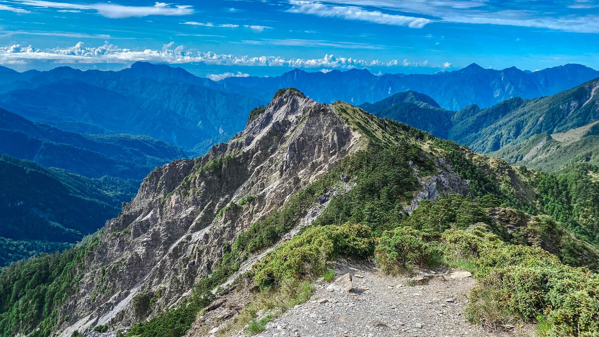 從南峰望巴巴山,要繼續上上下下翻過稜線,還要越過一段大斷崖。